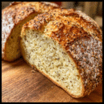 Low FOD bread loaf on a wooden board, sliced and served with avocado spread