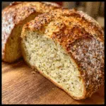 Low FOD bread loaf on a wooden board, sliced and served with avocado spread