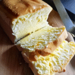 Freshly sliced Hawaiian Keto Bread on a wooden cutting board with tropical garnish