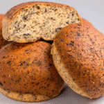 Assorted keto bread alternatives including almond flour, flaxseed, and cloud bread on a wooden board