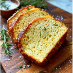Keto bread mix loaf fresh out of the oven with rosemary and seeds