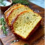 Keto bread mix loaf fresh out of the oven with rosemary and seeds